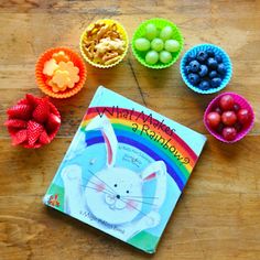 the children's book is next to bowls of fruit