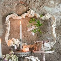 a table with flowers and candles on it