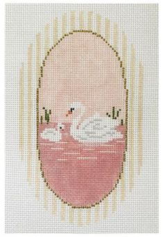 a cross stitch picture with two swans in the water and one duckling on it's back