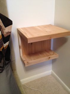 a wooden shelf sitting next to a white wall