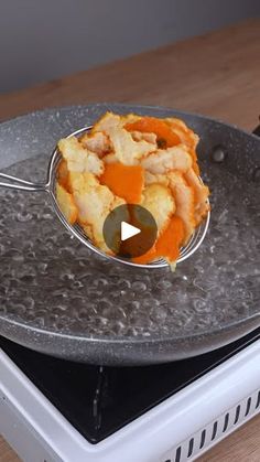 a metal plate with food on it sitting on top of a stove