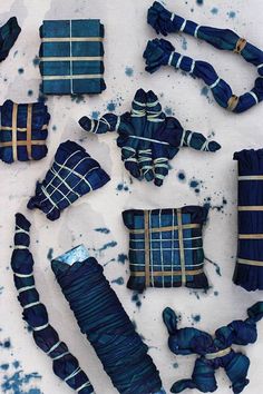 several pieces of blue and white fabric laid out on top of a sheet of paper