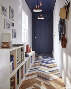 the hallway is decorated in blue and white with herringbones on the flooring