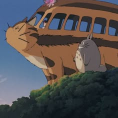 an animal and cat are standing in front of a bus on the side of a hill