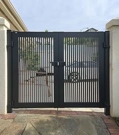 a car is parked in front of an iron gate that has been made into a driveway