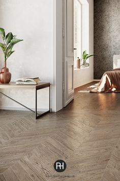 a bedroom with wood flooring and white walls in the background is an open door