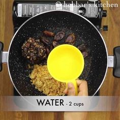 a person is pouring water into a pan with food in it and the words water - 2 cups below