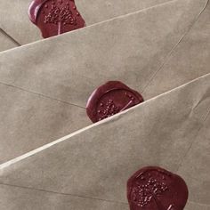 four waxed envelopes with stamps on them are lined up and ready to be mailed