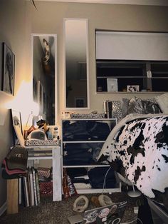 a messy bedroom with cow hide rugs and clutter on the floor next to it