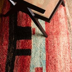 a coffee table sitting on top of a colorful rug