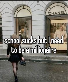 a woman walking down the street in front of a store with words saying school sucks but i need to be a millionaire