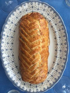 a loaf of bread sitting on top of a white and blue plate