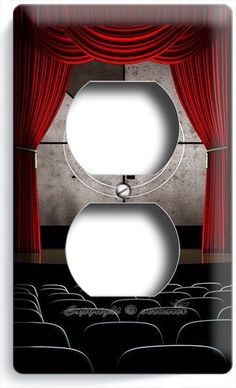 a light switch cover with a red curtain and theater scene in the backround