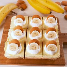 there are bananas and cream squares on the cutting board next to some other food items