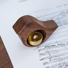 a wooden object sitting on top of sheet music