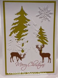 a christmas card with two deer and snowflakes on the trees in the background