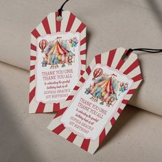 two circus themed thank you tags are on a couch with the tag attached to it