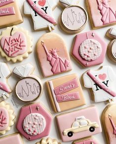 many decorated cookies are arranged on a table top with pink and white frosted decorations