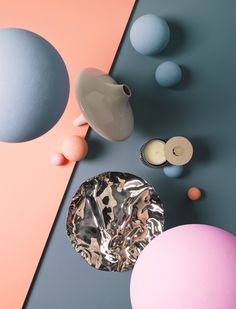 an assortment of different colored eggs and vases on a blue, pink, and grey background