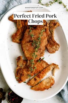 the perfect fried pork chops on a white plate