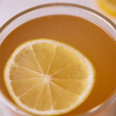 a glass filled with liquid and a lemon slice