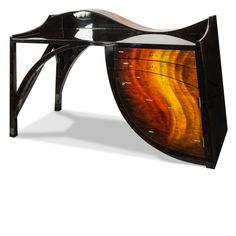 an artistic wooden table with glass top and metal legs, designed to look like a wave