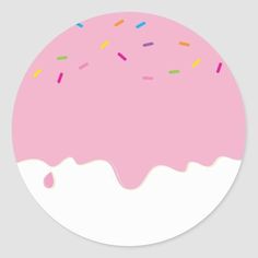 a pink frosted donut with sprinkles on it's side