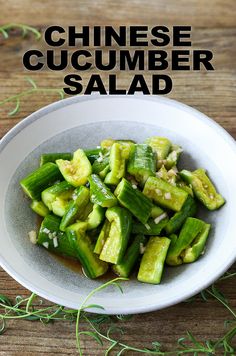 chinese cucumber salad in a white bowl on a wooden table with text overlay