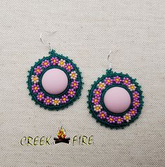 These are authentic Native American earrings, hand crafted by a member of the Muskogee Creek Tribe. Used in the handmade process are seed beads, acrylic cabochons and faux leather backing. The bead colors included in this pair are: alabaster yellow, teal green , pink and purple seed beads. They measure 2 inches wide and 1 1/2 inches long. They have stainless steel hypo-allergenic hooks for pierced ears. Beaded Earrings Native 1stdibs, Beaded Earring Edging, Beaded Studs Earrings, Beaded Earrings Native Beadwork Ideas, Beaded Earrings Native Beadwork, Muskogee Creek, Cab Earrings, Creek Tribe, Native American Beadwork Earrings