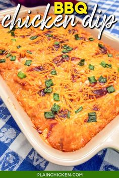 a casserole dish with cheese and green onions in it on a blue checkered tablecloth