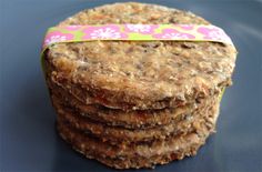 a stack of cookies sitting on top of a blue countertop next to a pink and green ribbon