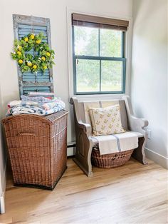 a wicker basket sitting next to a window in a room with wooden flooring