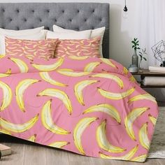 a bed with pink and yellow bananas on it