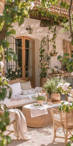 an outdoor patio with wicker furniture and potted plants