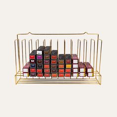 a rack filled with lots of different types of lipstick