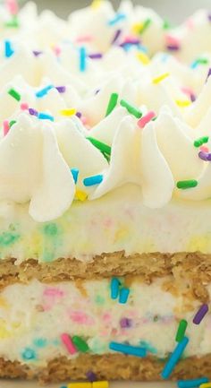 a cake with white frosting and colorful sprinkles