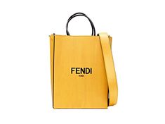 Introducing the Fendi Roma 2Way Vitello tote bag, fashioned from supple yellow leather embossed with the iconic Fendi Roma logo. Versatile and practical, the black suede interior includes a slip pocket and offers ample space for your daily essentials. Its 2-way design allows for effortless transition from a chic crossbody to a classic hand-held tote. The gleaming gold-tone hardware adds a touch of glamour, while the detachable shoulder strap ensures comfortable wear. Elevate your everyday ensemb Roma Logo, Crossbody Tote Bag, Yellow Leather, Timeless Accessories, Crossbody Tote, Leather Logo, Shopping Tote Bag, Fendi Bags, Shopping Tote