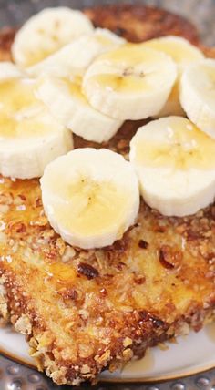 a plate topped with pancakes covered in bananas