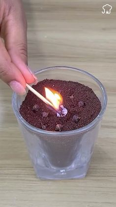 a person lighting a match stick in a cup