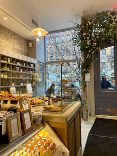 the inside of a bakery with lots of food and drinks on display in front of it