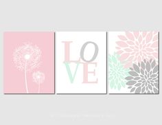 three wall art prints with flowers and the word love in pink, gray, and green