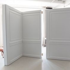 an open door is shown in the middle of a room with white walls and flooring