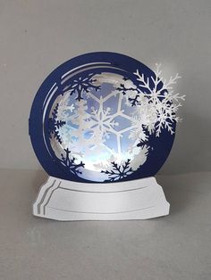 an ornament with snowflakes on it sitting on top of a table