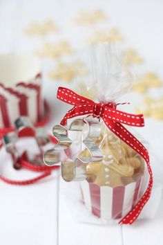 two small red and white striped boxes filled with treats