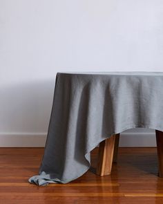 a wooden table with a gray cloth on it