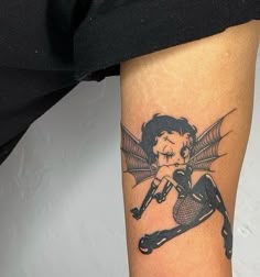 a woman with a bat tattoo on her leg