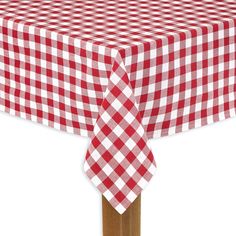 a red and white checkered tablecloth on a wooden pole