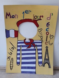 a cardboard cutout of a man in front of the eiffel tower with words on it