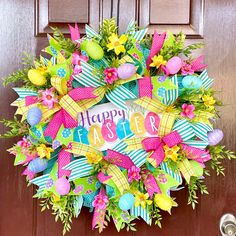 a colorful easter wreath on the front door