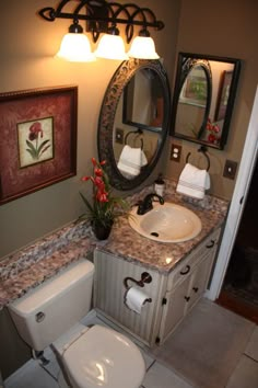 a bathroom with a toilet, sink and mirror in it's centerpieces